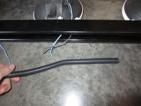 1992 Ford Bronco - Close-up of a light bar with wiring and conduit, likely for vehicle accessory installation.
