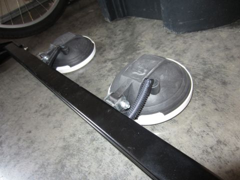 1992 Ford Bronco - Two off-road lights are shown on a concrete surface, with a black metal bar in the foreground.