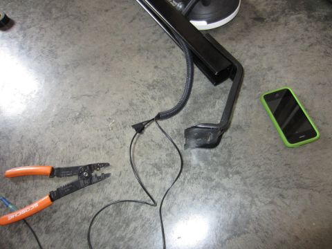 1992 Ford Bronco - A car part, wire strippers, and a smartphone are laid out on a concrete floor.