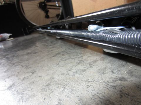 1992 Ford Bronco - This image shows a close-up view of a spring and bolt assembly, likely a component of a larger mechanism or vehicle part.