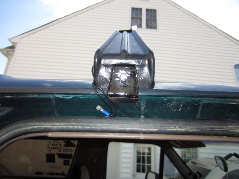 1992 Ford Bronco - A black light bar mount is affixed to the roof of a dark green vehicle.