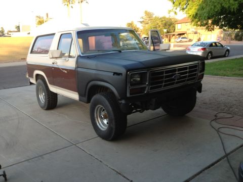 1982 Ford Bronco - This 1982 Ford Bronco is parked on a concrete driveway with its doors open.