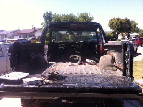 1989 Ford Bronco - The interior of a 1989 Ford Bronco is exposed, with the bed and cab stripped down for work.