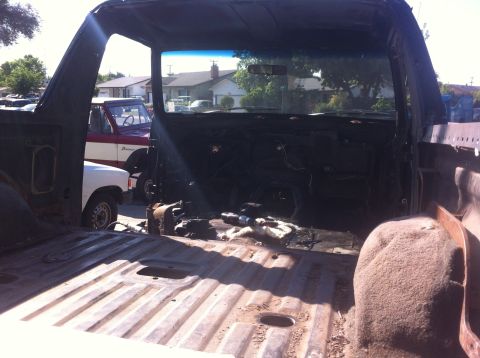 1989 Ford Bronco - Interior view of a disassembled 1989 Ford Bronco, with another Bronco in the background.