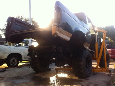 1989 Ford Bronco - The body of a 1989 Ford Bronco is suspended by an engine hoist during a tub swap operation.