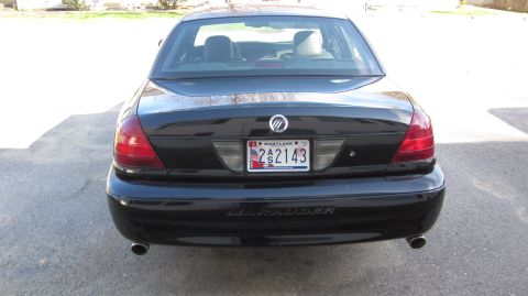 2003 Mercury Marauder - Black 2003 Mercury Marauder sedan parked outdoors, showing its rear end and dual exhaust pipes.