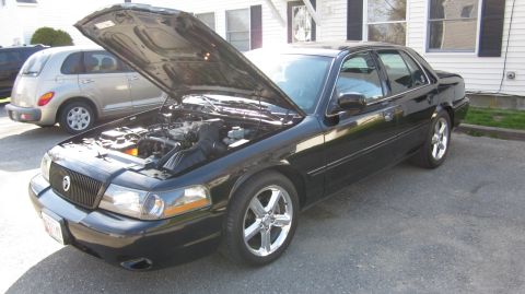 2003 Mercury Marauder - The hood is open on this black 2003 Mercury Marauder, revealing the engine bay.