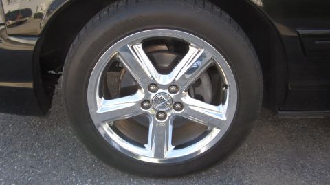 2003 Mercury Marauder - Chrome wheel with Mercury logo on a black vehicle.