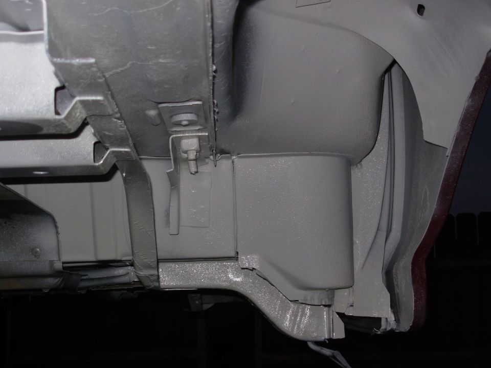 Gray-painted vehicle underbody frame and bracket, restoration view