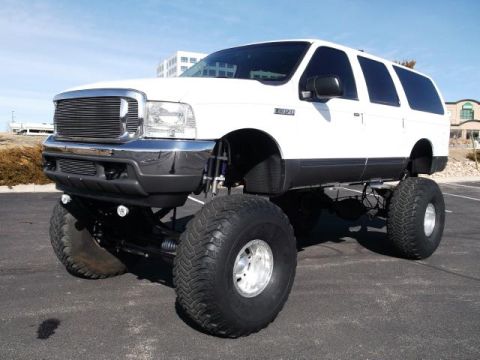 2001 Ford Excursion - This lifted 2001 Ford Excursion features a prominent grille and large off-road tires, giving it an imposing stance.