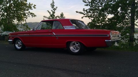 1964 Ford Fairlane - This red 1964 Ford Fairlane coupe is shown from the rear three-quarter angle.