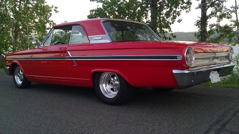 1964 Ford Fairlane - This red 1964 Ford Fairlane coupe features chrome wheels and a distinctive body style.
