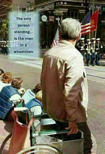 1987 Ford Bronco - A man in a wheelchair observes a parade, with a message about the only person standing being in a wheelchair.