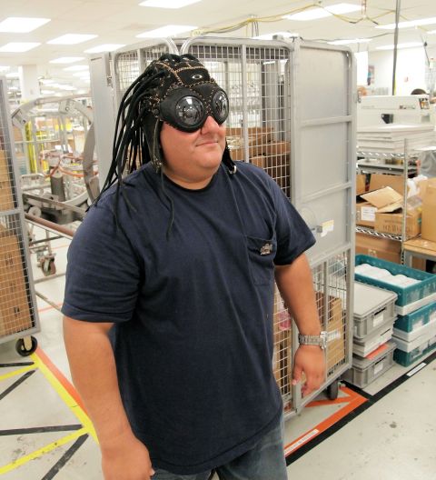 2012 Ford Bronco - A person poses in a warehouse setting, sporting a unique hat with goggles and faux dreadlocks.