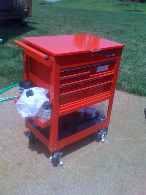 1992 Ford Bronco - A red rolling tool chest with multiple drawers sits on a concrete surface outdoors.