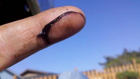 1978 Ford Bronco - Oil smudge on a finger, indicating engine maintenance.