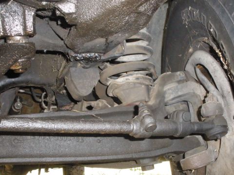 1988 Ford F-250 - Close-up view of the undercarriage, focusing on the steering and suspension system.