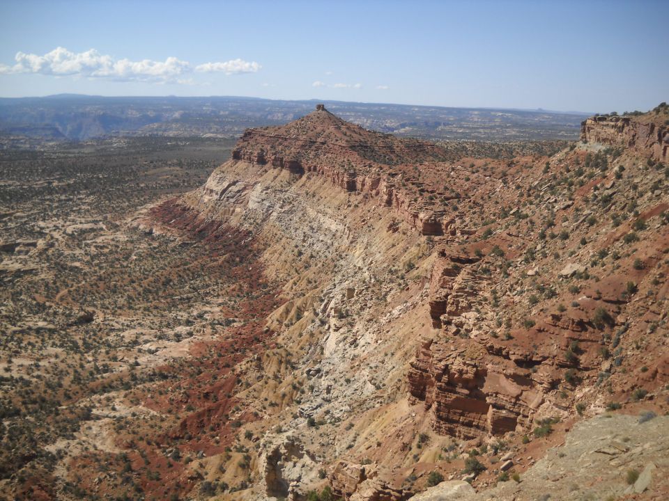 Desert landscape with mesas and canyons under a blue sky