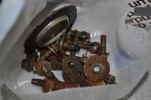 1986 Ford Bronco - A collection of corroded fasteners and a gasket are shown in a plastic bag.