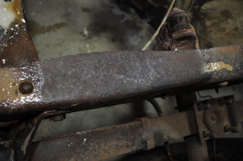 1986 Ford Bronco - Close-up of a heavily rusted frame rail, showing signs of wear and potential structural issues.
