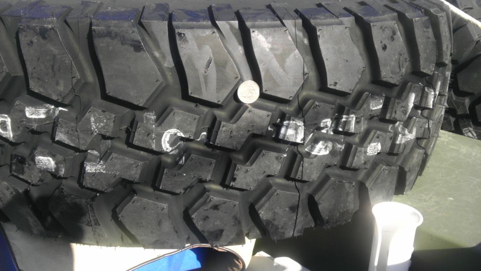 Off-road tire with a coin on its tread