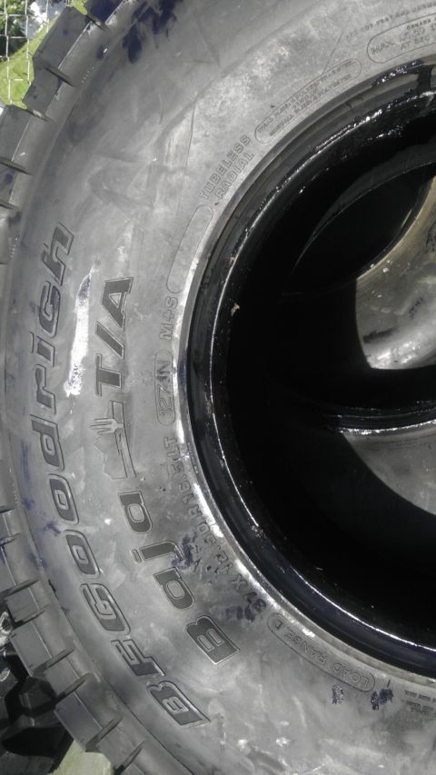 1989 Ford Bronco - Close-up of a BFGoodrich All-Terrain T/A tire mounted on a black wheel rim.