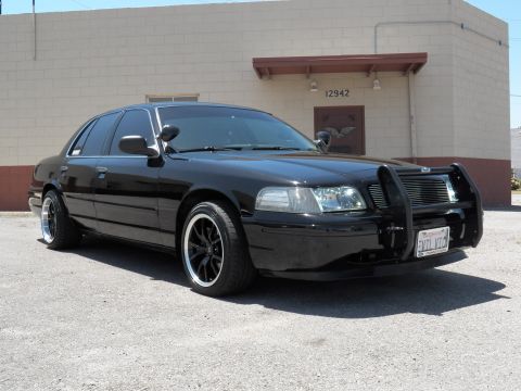 2003 Ford Crown Victoria - Front quarter view of a black Crown Victoria fitted with a push-bar grille guard.