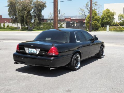 2003 Ford Crown Victoria - Rear quarter of a black Crown Victoria showing an EVTL VIC plate and SVT badge.
