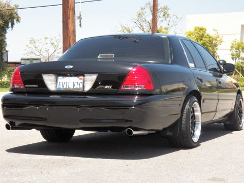 2003 Ford Crown Victoria - Close rear three-quarter of a black Crown Victoria showing trunk, EVTL VTC plate and SVT emblem.