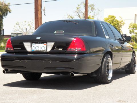 2003 Ford Crown Victoria - Rear quarter view of a black lowered Crown Victoria with dual exhaust tips and tinted glass.