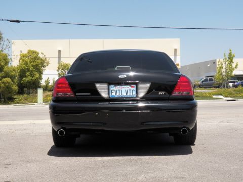 2003 Ford Crown Victoria - Straight rear view of a black Crown Victoria, EVTL VTC plate centered between dual exhaust tips.