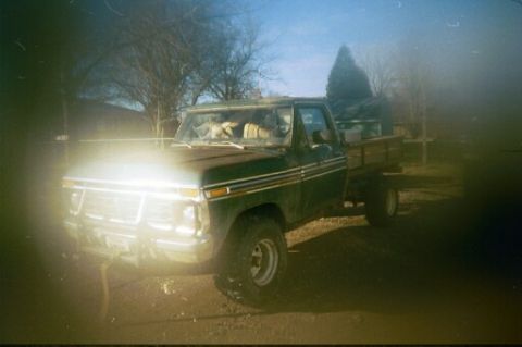 1979 Ford Bronco - This 1977 Ford F-150 pickup truck features a flatbed and is shown from a 3q front angle.