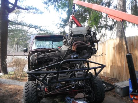 1988 Ford Bronco - Engine removal in progress, with a custom bumper and PIAA lights visible.