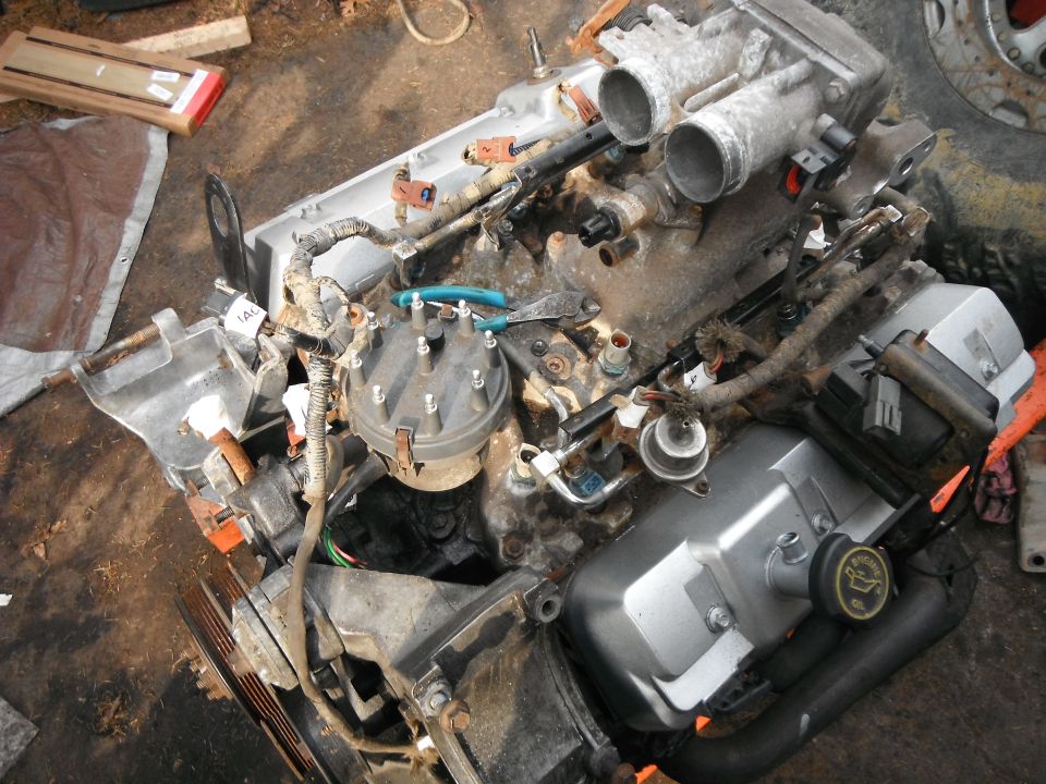 Engine with distributor and valve cover