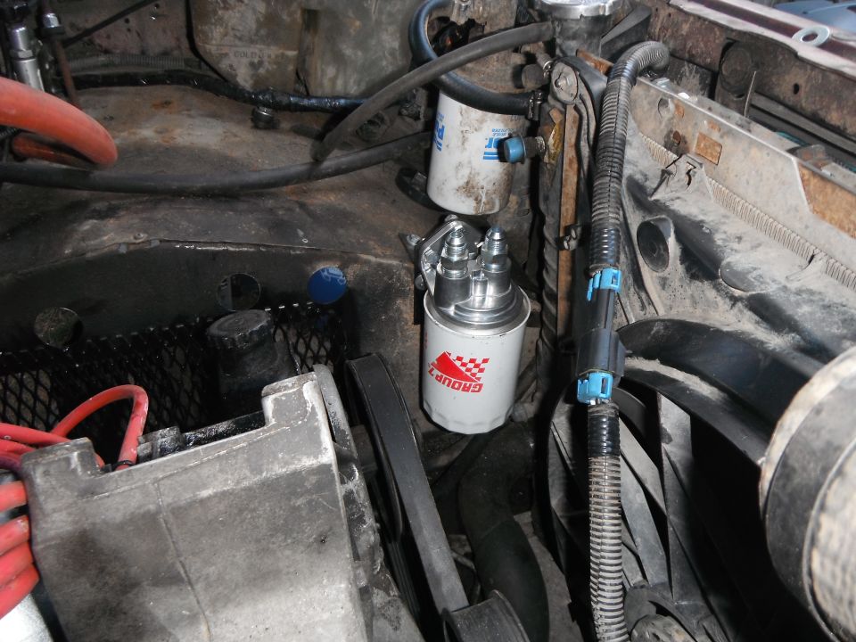 Engine bay shot showing a fuel filter assembly and hoses