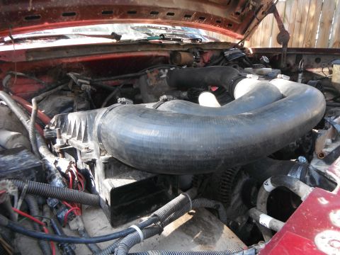 1988 Ford Bronco - Close-up view of a vehicle's engine bay, showing complex plumbing and wiring.