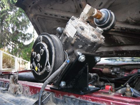 1988 Ford Bronco - Custom air conditioning compressor installation in an engine bay, with visible Supermotors.net branding.