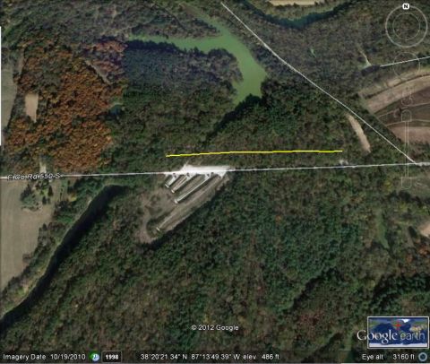 1995 Mercury Grand Marquis - An aerial perspective captures a landscape a body of water, a road, and several long, narrow structures.