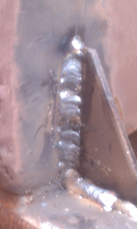 1979 Ford Bronco - A close-up view shows a metal bracket with a prominent weld seam, indicating repair or fabrication work.