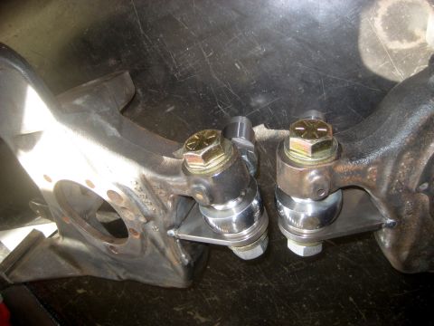 1996 Ford Bronco - Close-up view of a steering knuckle and ball joint assembly, prominent bolts and metal components.