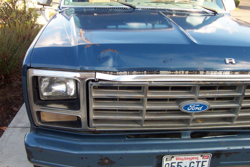 Blue 1980 Ford Bronco front grille with Ford logo and square headlights
