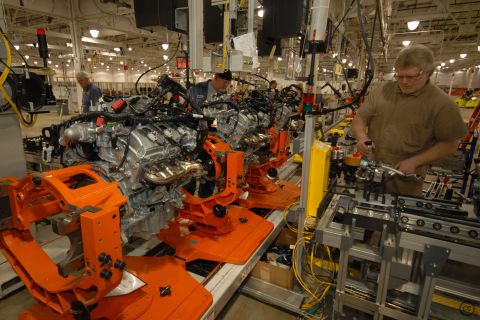 1997 Ford Taurus - Workers assemble V-engines on a factory production line.