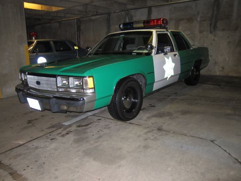 1991 Ford Crown Victoria - This 1991 Ford Crown Victoria police car is parked indoors, with another vehicle behind it.