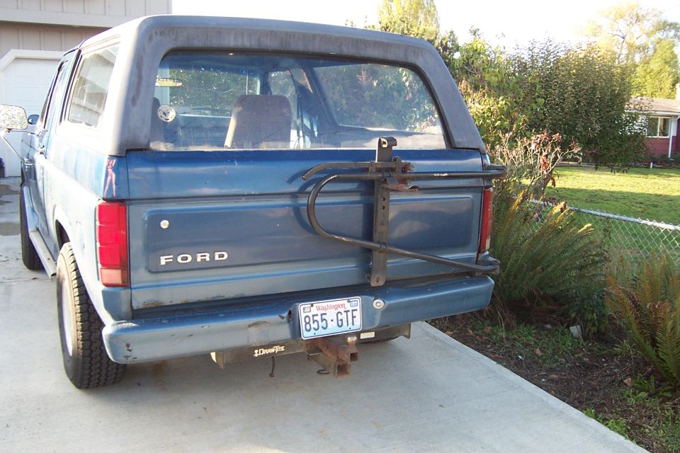 Blue 1980 Ford Bronco rear view with spare tire carrier