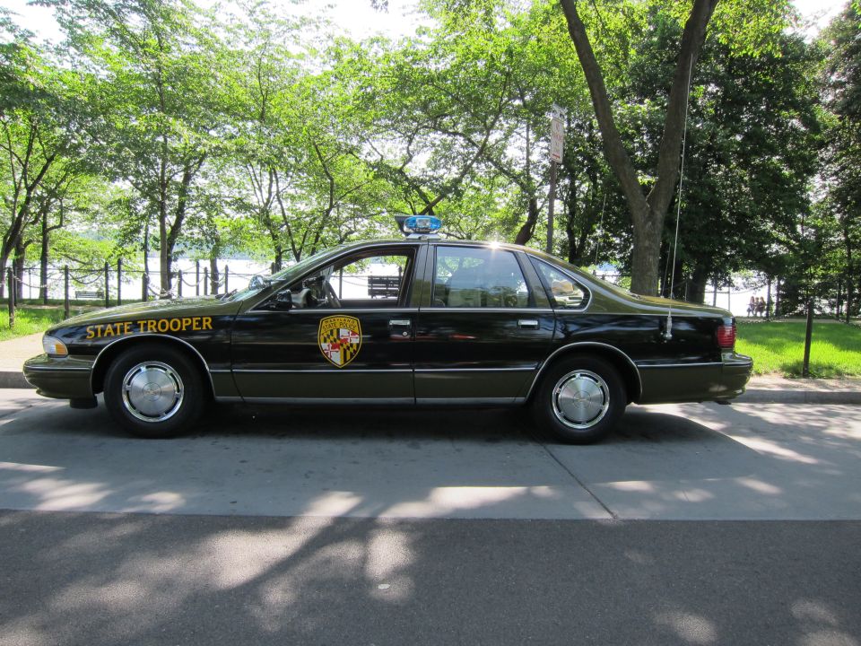 Black Maryland State Trooper Chevrolet Caprice sedan, side profile outdoors