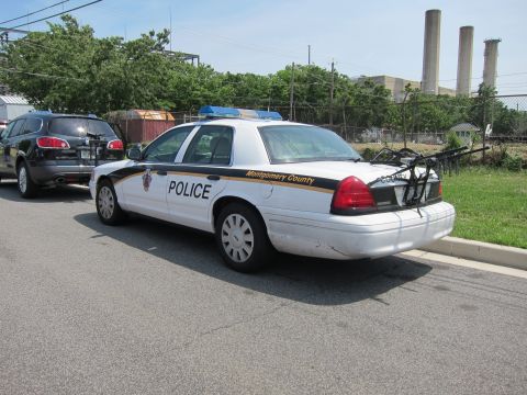 1991 Ford LTD Crown Victoria - Rear view of a white Montgomery County Police Ford Crown Victoria with light bar and bike rack.