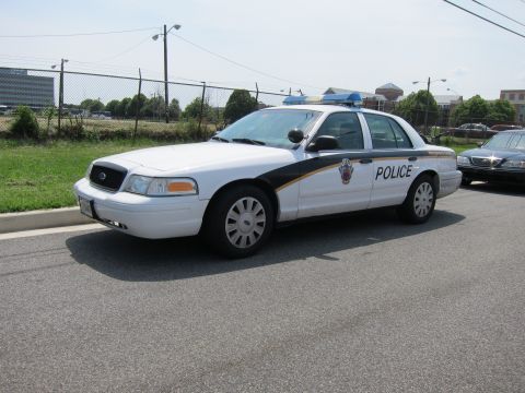 1991 Ford LTD Crown Victoria - white Montgomery County Police Ford Crown Victoria parked along a fence with blue roof lights.