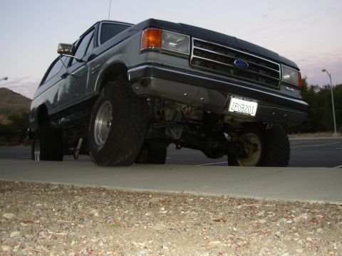 1989 Ford Bronco - This lifted Ford Bronco has a two-tone paint job and large off-road tires.