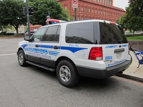 1991 Ford LTD Crown Victoria - Rear three-quarter view of a white Washington County Maryland Deputy Sheriff Ford Expedition with red bicycle nearby.