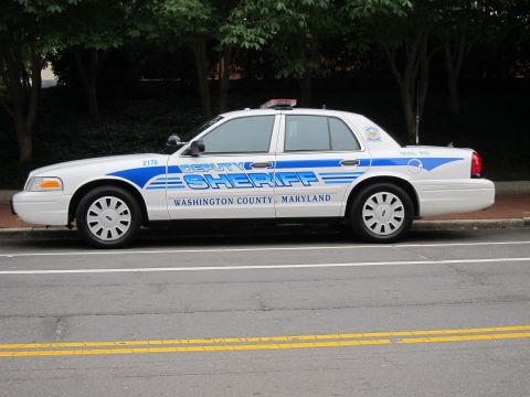 1991 Ford LTD Crown Victoria - white Ford Crown Victoria marked Deputy Sheriff, Washington County Maryland, with blue stripes parked curbside.